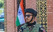 An Indian paramilitary soldier stands guard as supporters of India's Bharatiya Janata Part...