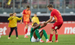 Tomislav Papazov of Birkirkara helps Elvis Mashike Sukisa of Floriana to get up from the p...