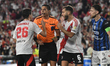 Referee Jesus Valenzuela argues with Ignacio Fernandez and German Pezzella of River Plate...