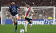 Milton Casco of River Plate competes for the ball with Cristian Zabala of Independiente de...