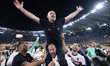 Vincenzo Italiano, head coach of Bologna FC, is carried in triumph by his players during t...