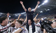 Vincenzo Italiano, head coach of Bologna FC, is carried in triumph by his players during t...