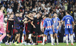 FC Barcelona players celebrate the La Liga championship while Pere Milla of RCD Espanyol c...