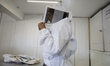 Martha Flores Garcia, a beekeeper, works with bees and breeding chambers between the borde...