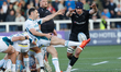John Hawkins of Newcastle Falcons tries to charge down a kick by Tomos Williams of Glouces...