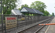 Railroad crossing gates remain up, and the platform is empty with no commuters as New Jers...