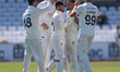 Codi Yusuf of Durham celebrates with his teammates after taking the wicket of Nottinghamsh...