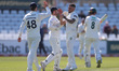Codi Yusuf of Durham celebrates with his teammates after claiming the wicket of Nottingham...