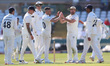 Codi Yusuf of Durham celebrates with his teammates after claiming the wicket of Nottingham...
