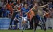 Joe Pritchard of Oldham Athletic celebrates his team's third goal with fans on the pitch d...