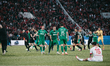 Ludogorets players celebrate wildly as the match ends, running and jumping, while CSKA Sof...