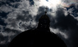 The silhouette of the dome and the cross on the Humboldt Forum is pictured from its roofto...