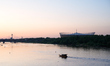 A small boat is seen on the Vistula river with the National Stadium in the background in W...