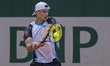 Marton Fucsovics returns the ball against Tristan Schoolkate at the Roland Garros Grand Sl...