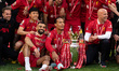 Liverpool's Wataru Endo, Mohamed Salah, Virgil van Dijk, and Arne Slot hold the Premier Le...
