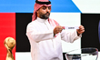 Former Saudi Arabian footballer Yasser Al-Qahtani shows a result paper bearing the name of...