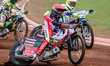 Belle Vue Aces' Dan Bewley in red rides outside Oxford Spires' Peter Kildemand in yellow d...