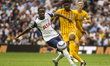 Carlos Baleba of Brighton & Hove Albion is pressured by Pape Matar Sarr of Tottenham Hotsp...