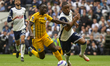 Destiny Udogie of Tottenham Hotspur and Yankuba Minteh of Brighton & Hove Albion battle fo...