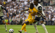 Destiny Udogie of Tottenham Hotspur and Yankuba Minteh of Brighton & Hove Albion battle fo...