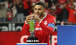 Alexis Vega #9 of Toluca touches the trophy as he celebrates after winning the Liga MX Cla...