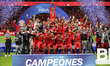 Alexis Vega #9 of Toluca lifts the trophy with teammates during a ceremony for the Mexican...