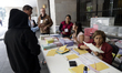 Polling station officials participate in the Judicial Branch Election Day to elect ministe...