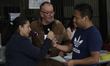 A polling station official paints a person's finger after he casts his ballot during the J...