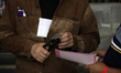 A polling station official marks a person's voting card after he casts his ballot during t...