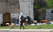 Boarded storefronts, illegal dumping, abandoned apartment buildings, and economic decay do...