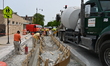 City of Chicago construction contractor crews pour and smooth fresh concrete along Milwauk...