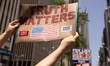 Protesters hold signs and chant outside of Fox News headquarters in New York City, USA, on...