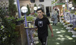 A waiter serves tea to clients in the Darband neighborhood in northern Tehran, Iran, on Ju...