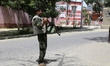 A policeman stands guard near the attack site in Ghazni City, capital of Ghazni Province,...