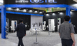 Visitors explore products on display at COSTEL's booth during EV Trend Korea 2025, the nat...