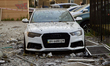 A car parked outside an apartment block in the Solomianskyi district is damaged by an over...
