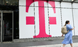 WASHINGTON, DC - MAY 27: A woman walks past the T-Mobile logo, in Washington, District of...