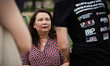 Sen. Tammy Duckworth (D-IL) talks with people backstage after speaking at a rally for vete...