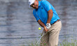Angel Cabrera hits a chip shot from the rough during round 1 of The American Family Insura...