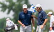 Steve Stricker (left) celebrates a chip shot for birdie on hole 8 with Mario Tiziani (righ...