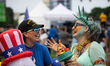 Patricia Sauceda Kraemer (L) and Neila Solano, both in costume, talk during a rally for ve...
