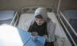 An elderly Iranian woman sits in her bed at Kahrizak Charity Nursing Home in southern Tehr...