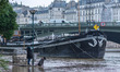 People look at the flooded Seine river after torrential downpours caused the Seine river t...