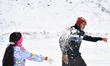 People play with snow after a snowfall during the winter season in Castle Hill, located in...