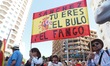 Protesters carry a banner in the colors of the Spanish flag that reads: ''Sanchez, you are...