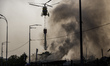 A firefighting helicopter is deployed to extinguish massive fires that engulf Kyiv followi...