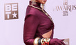 Mya wearing Michael Costello with an Alexis Bittar bag and jewelry arrives at the BET Awar...