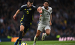 Mikael Egil Ellertsson of Iceland and Scott McTominay of Scotland play during an Internati...