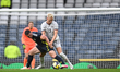 Hordur Magnusson of Iceland and John McGinn of Scotland vie for the ball during an Interna...