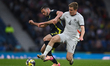 Isak Bergmann Johannesson and John Souttar vie for the ball during an International Friend...